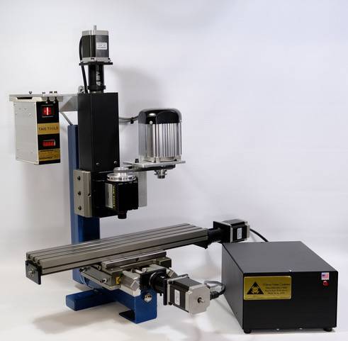 TAIG Tools 5023DSLS CNC Micro Mill machining a small aluminum part in a well-lit workshop.
